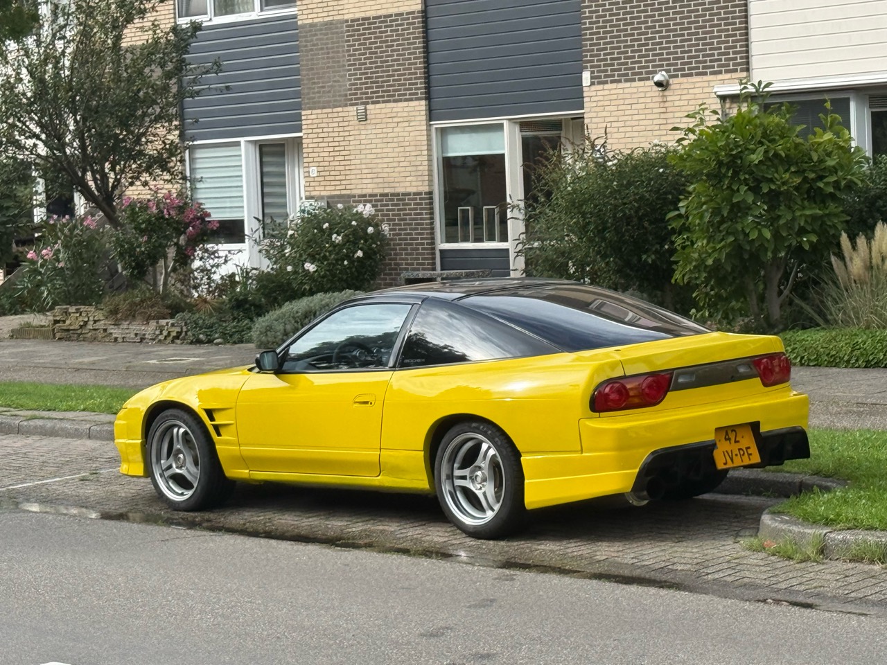 Traffic Yellow Nissan 200SX S13 parked at home after passing its APK