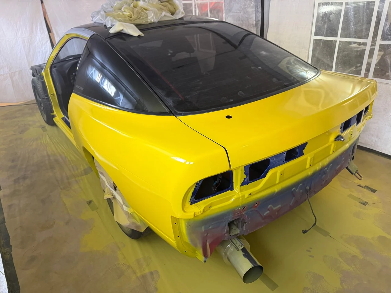 Rear quarters and boot of the S13 freshly painted Traffic Yellow